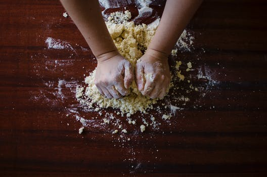 Carbs in Cornstarch: person kneading dough with almond flour